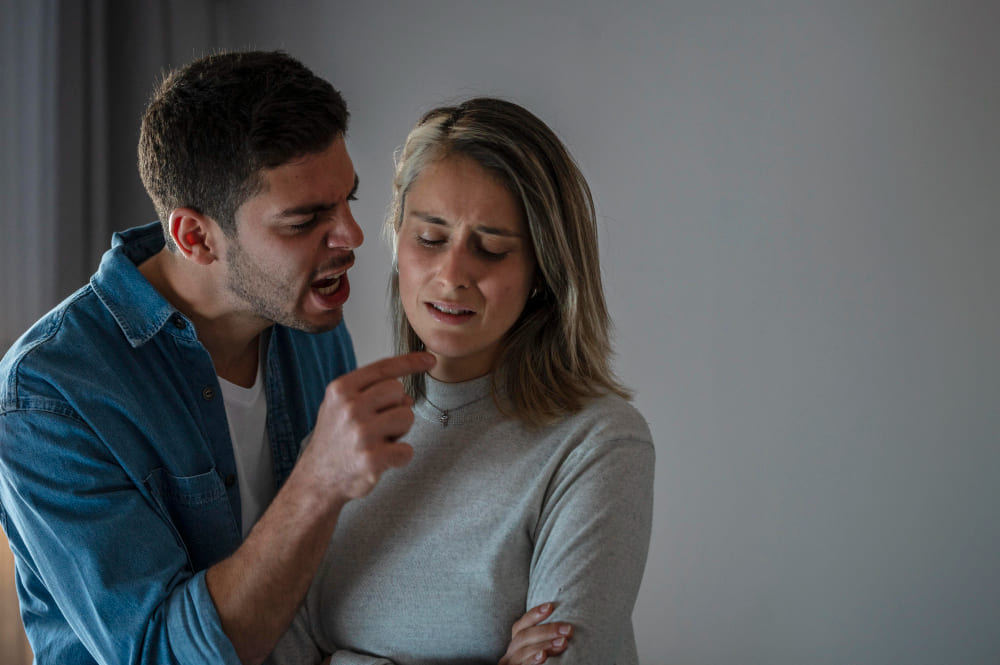 Homem gritando muito próximo ao rosto de uma mulher